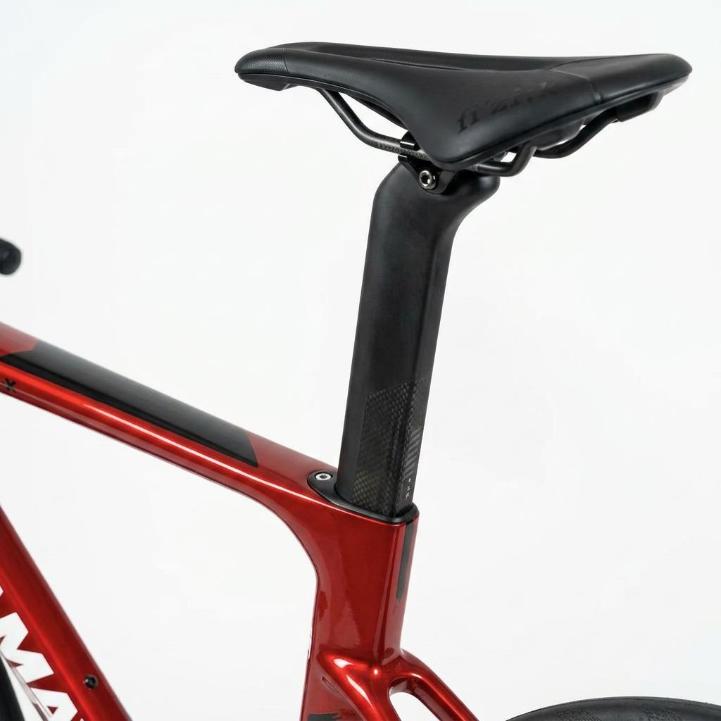 Close-up of a red bicycle frame with a black seat and seat post on a white background
